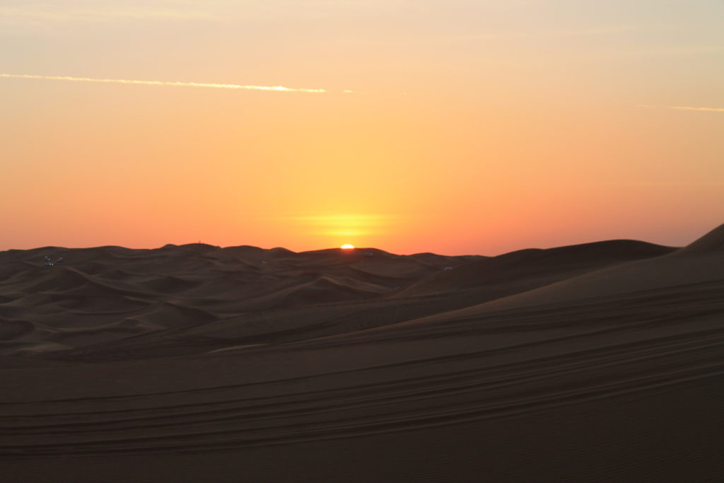 Having a break from the Dubai Sand Dune Safari to watch the sunset over the dessert