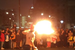 Fire breathing street performer in Trafalgar Square at night