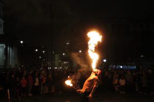 Fire breathing street performer in Trafalgar Square at night