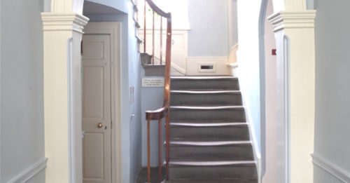 Hallway in the Bronte Parsonage, with beautiful duck egg blue walls and slate floors.