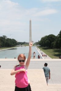 ArgeyDaughter holding up the Washington Monument with her finger.