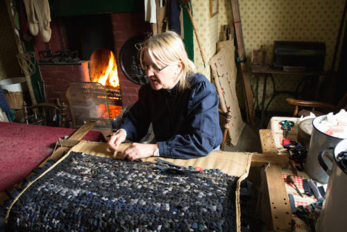 Beamish 1900s Pit Village Residence - Homemaker maker a rug out of old worn clothes